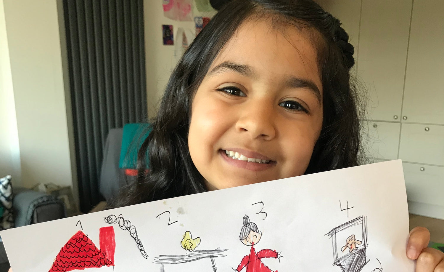 A child holding up their home learning