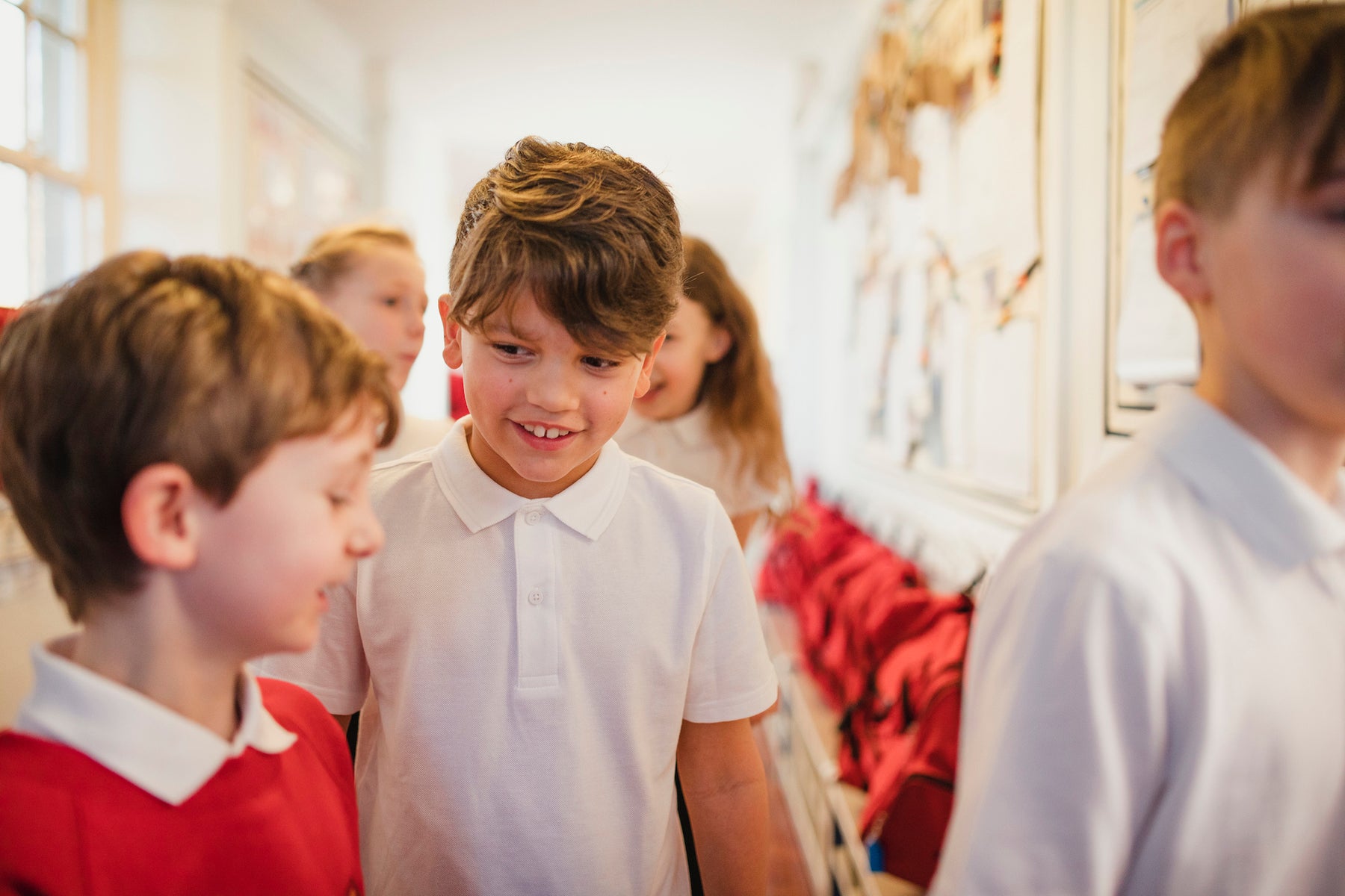 What Makes a Good Friend primary school children in a school hallway