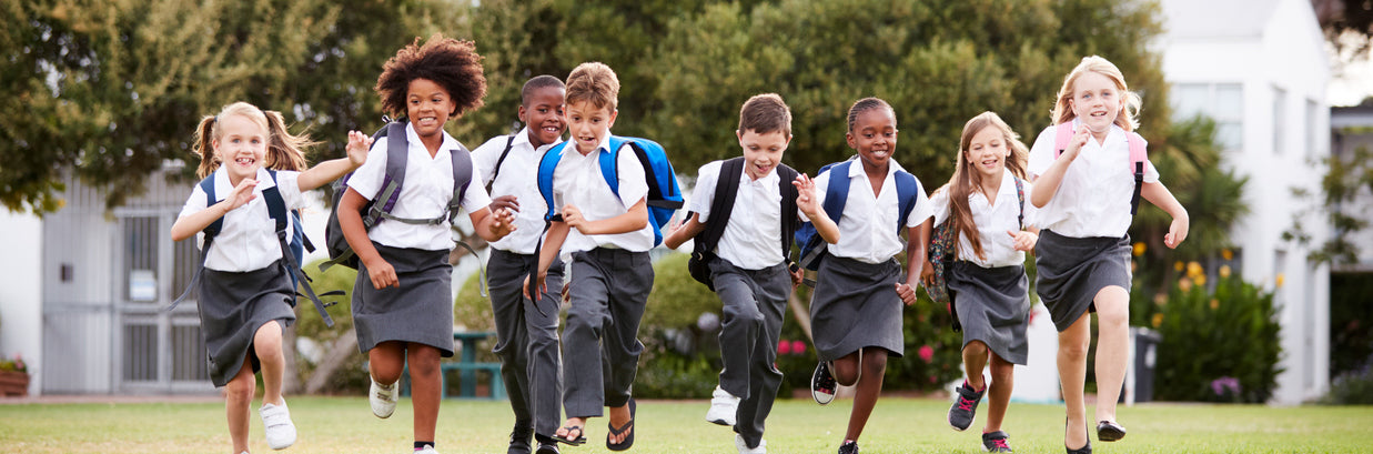 Children in school uniform running towards the camera