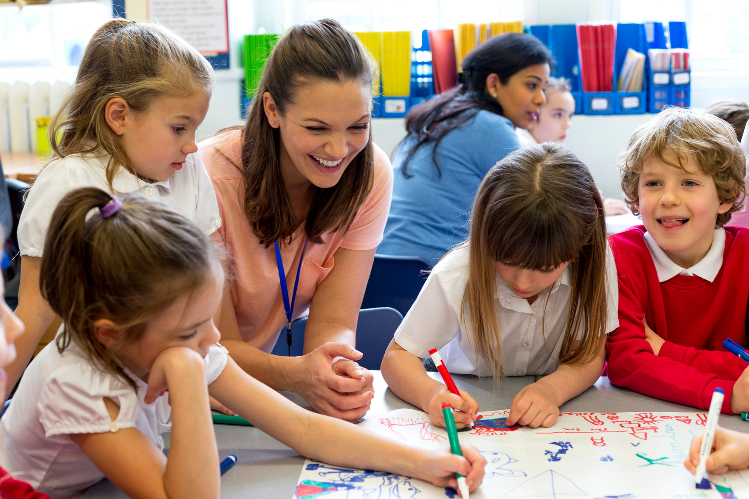 A teacher working with a group of children