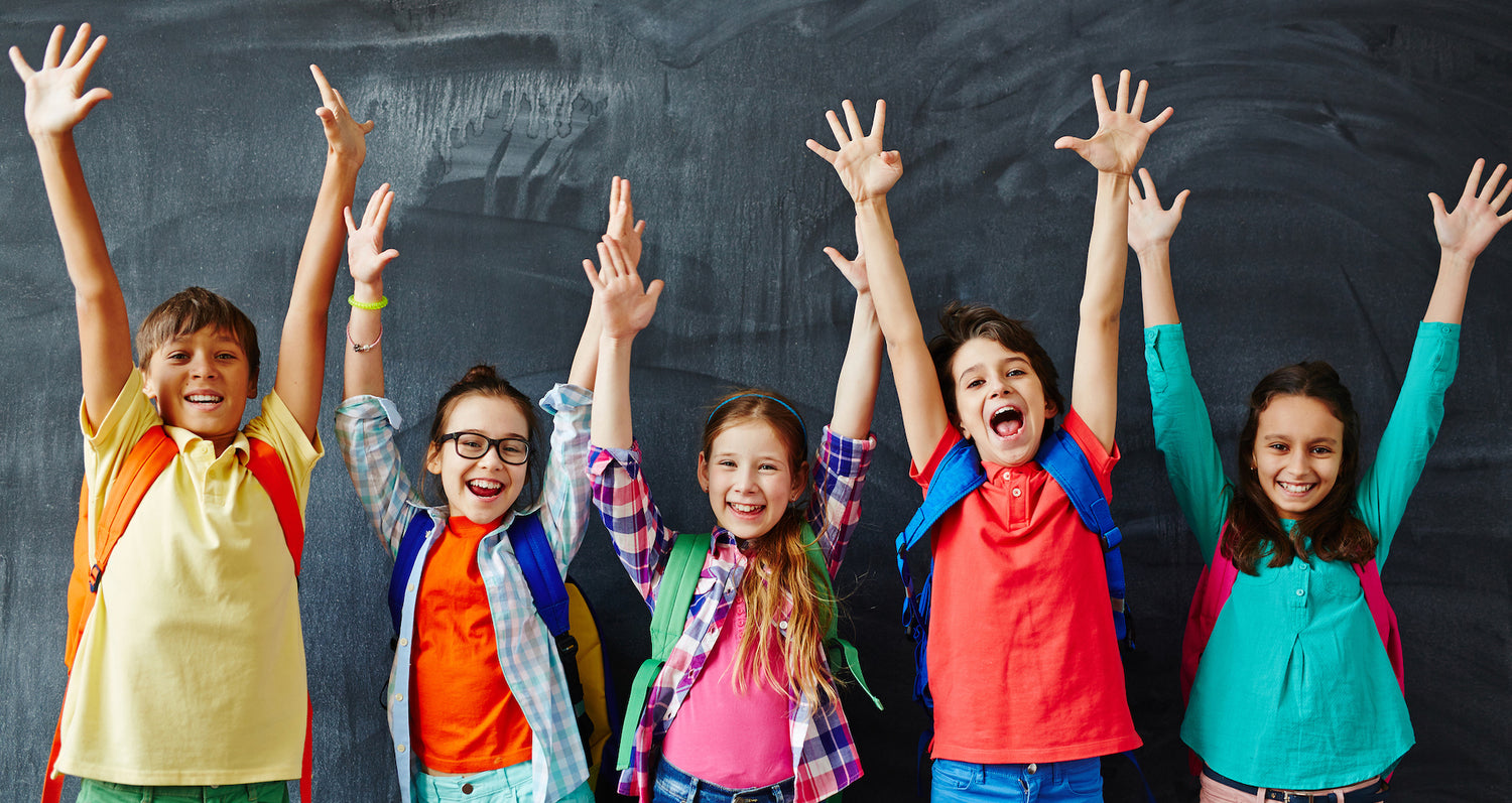 Happy children with raised hands