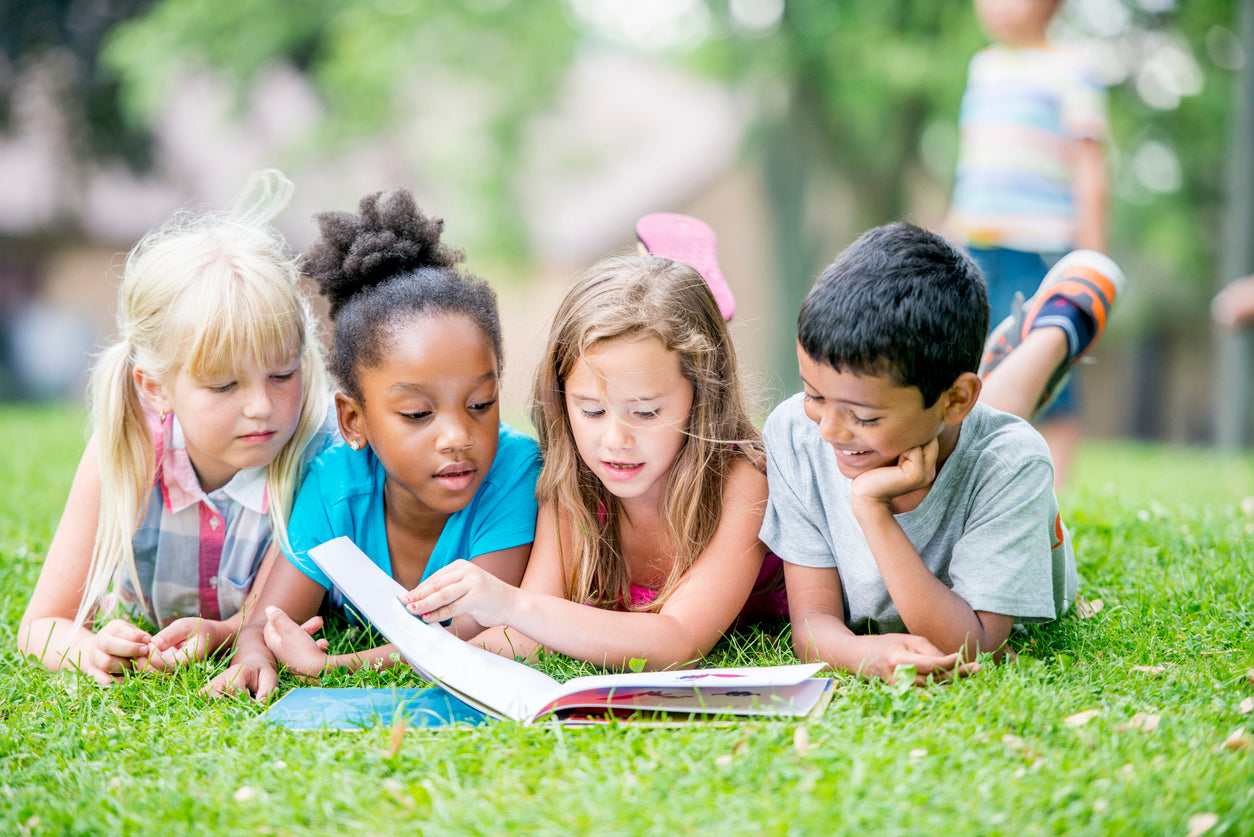Children reading outside
